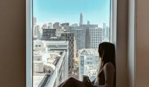 A person sitting quietly with a notebook, taking time to reflect